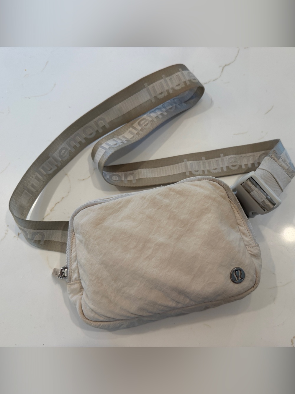 Lululemon cream belt bag with spell out logo strap